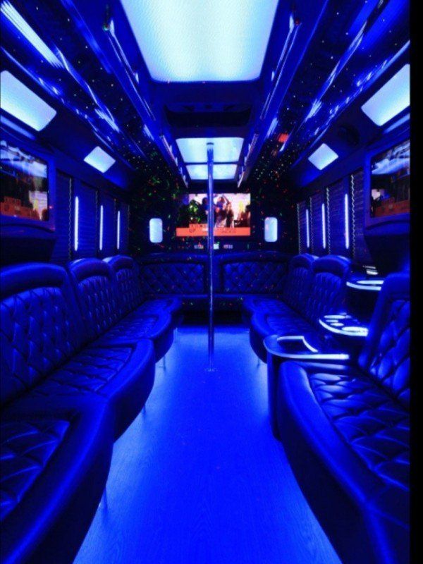The inside of a bus is lit up with blue lights