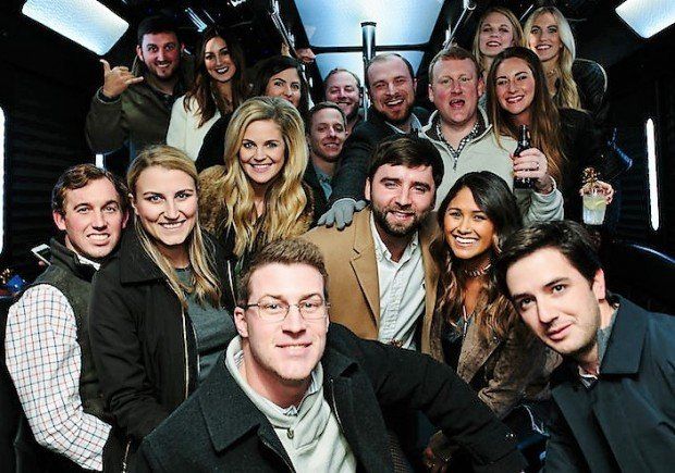 A group of people posing for a picture in a dark room