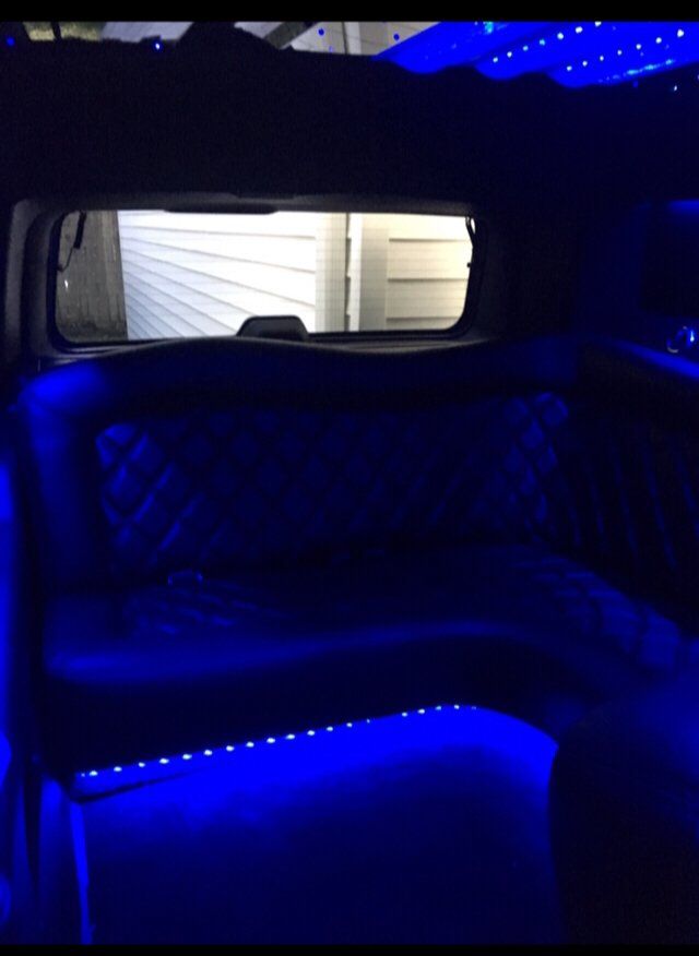 The back seat of a car with blue lights on it.