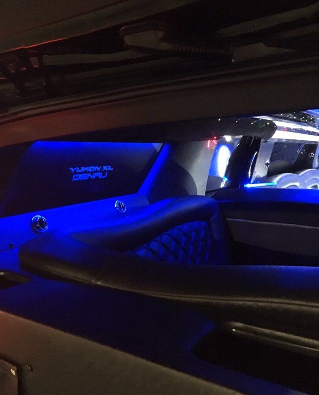 The inside of a car with blue lights and the word turbo on the back