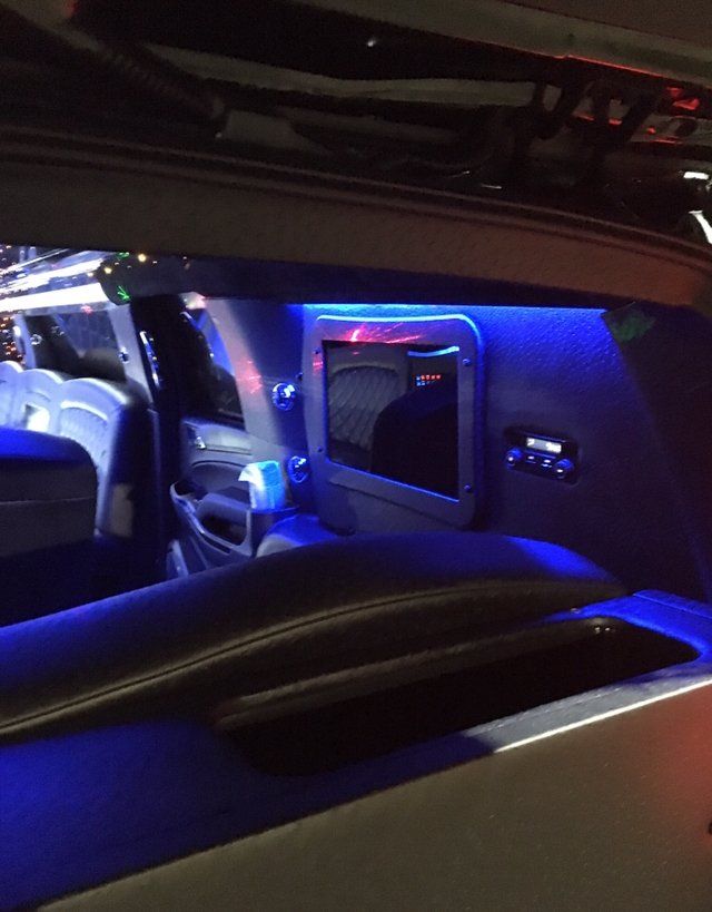 The inside of a car with blue lights on the seats