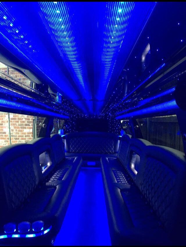 The inside of a limousine with blue lights on the ceiling