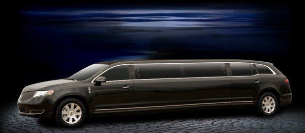 A black limousine is parked on the side of the road