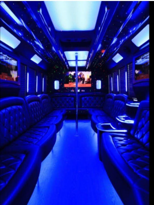 The inside of a bus is lit up with blue lights