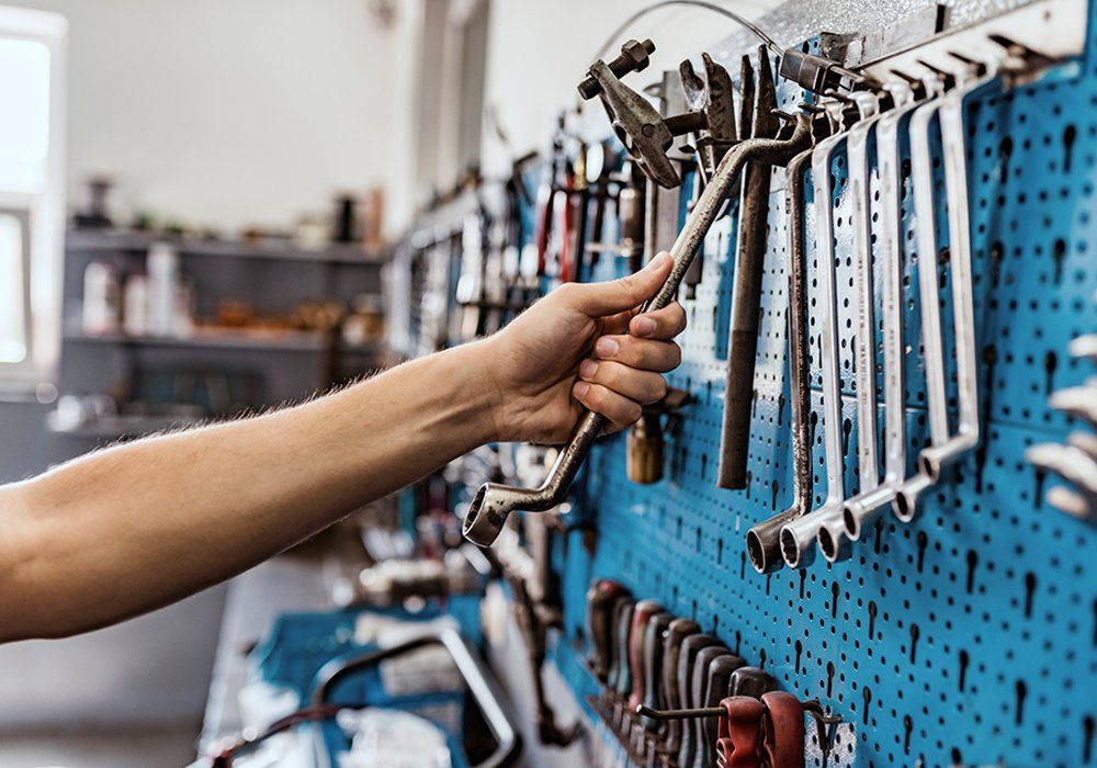 Person Putting Back The Tools — Hagerstown, MD — Guaranteed Truck & Auto Repair