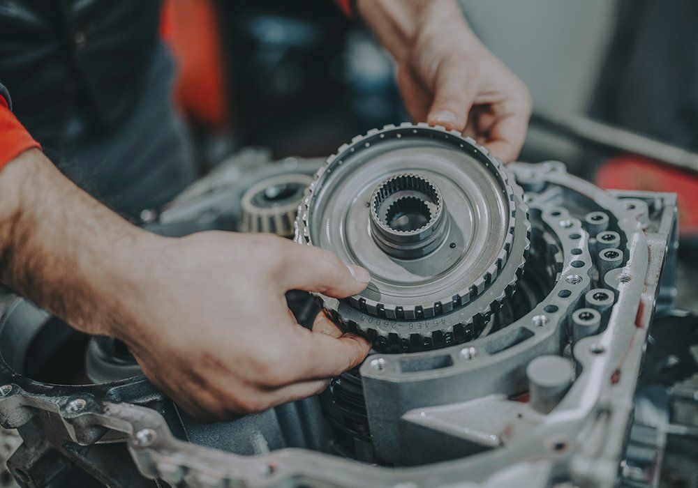 Person Repairing The Gearbox — Hagerstown, MD — Guaranteed Truck & Auto Repair