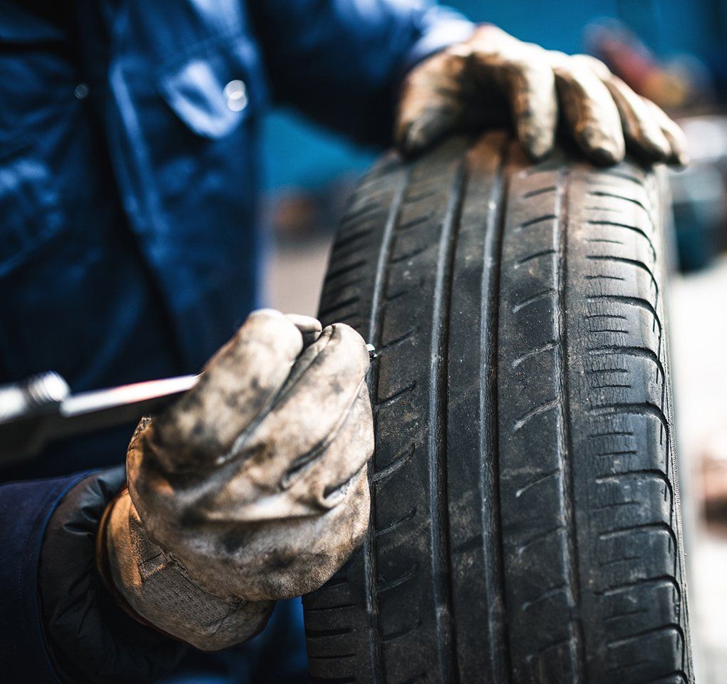 Man Doing Tire Repair — Hagerstown, MD — Guaranteed Truck & Auto Repair