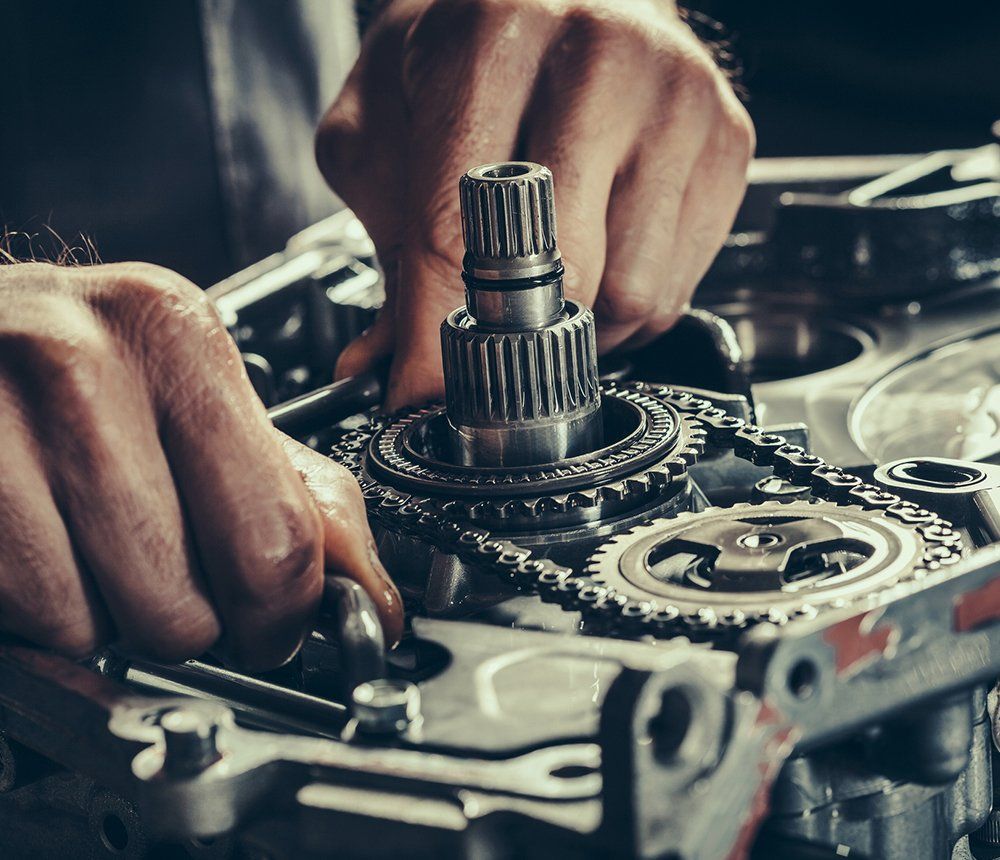 Person Fixing The Gearbox — Hagerstown, MD — Guaranteed Truck & Auto Repair