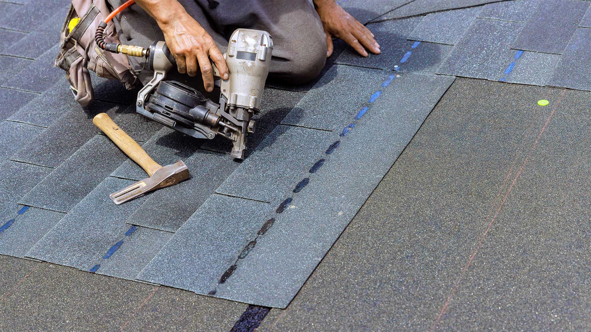 guy putting roofing panels down