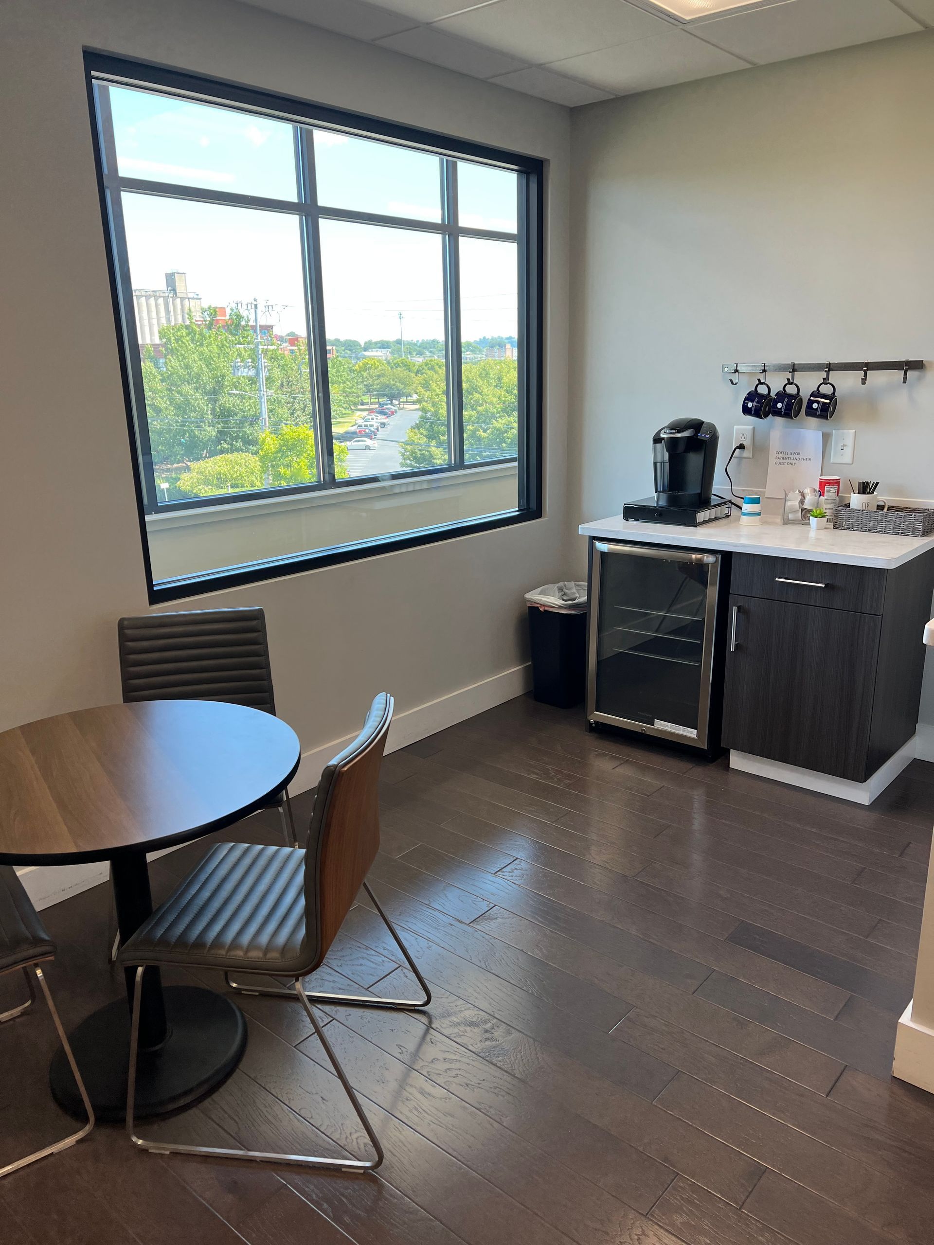 A kitchen with a table and chairs and a window.