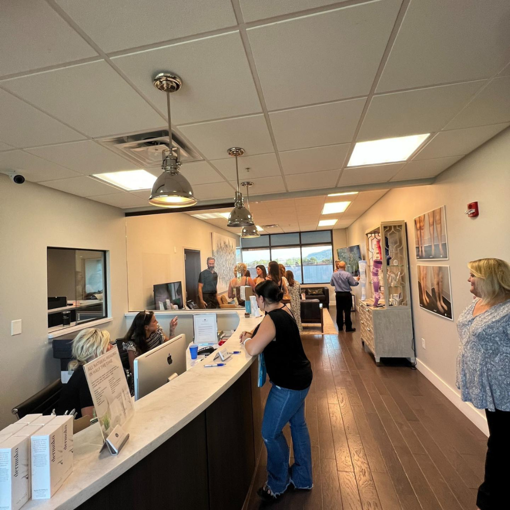 A woman is standing at a counter in a large room
