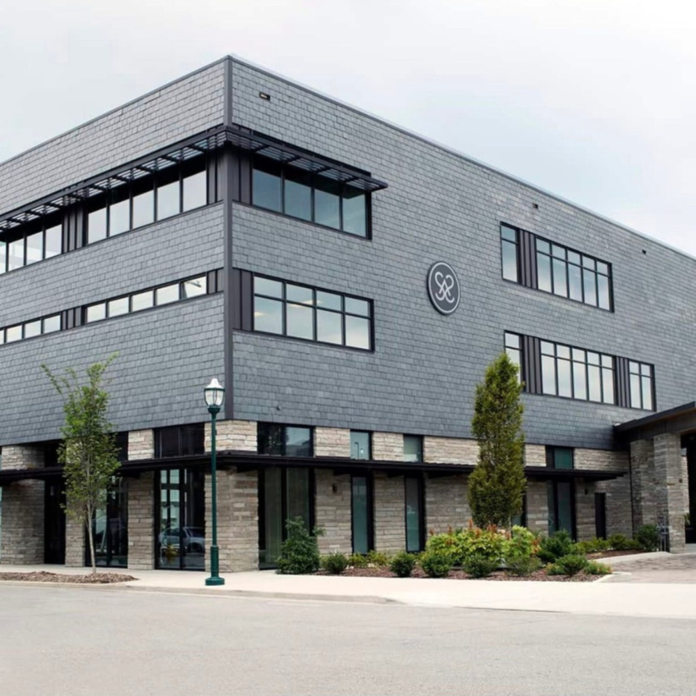 A large gray building with a heart on the side of it