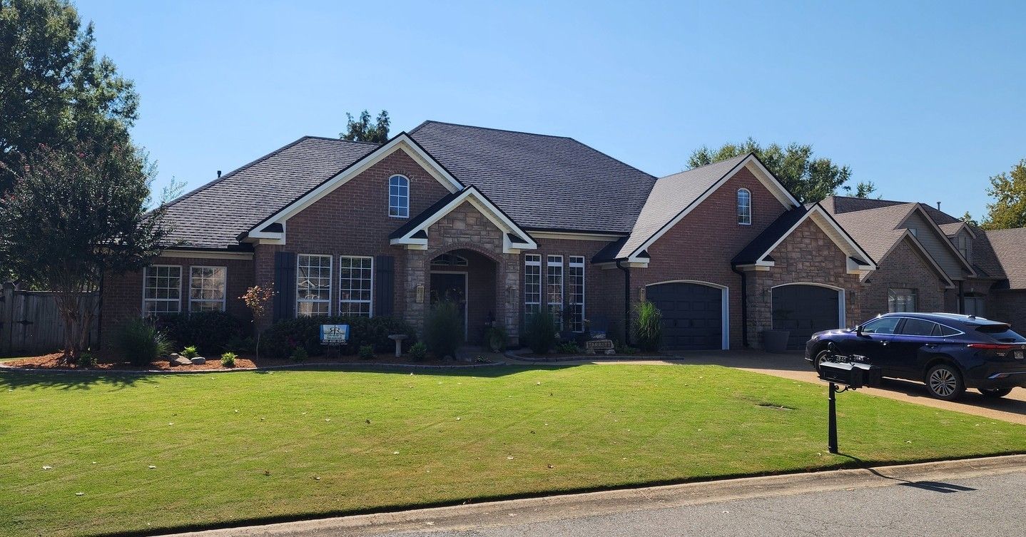 Wooden roof structure with dark insulation and protective layer, angled upward against a blue sky.