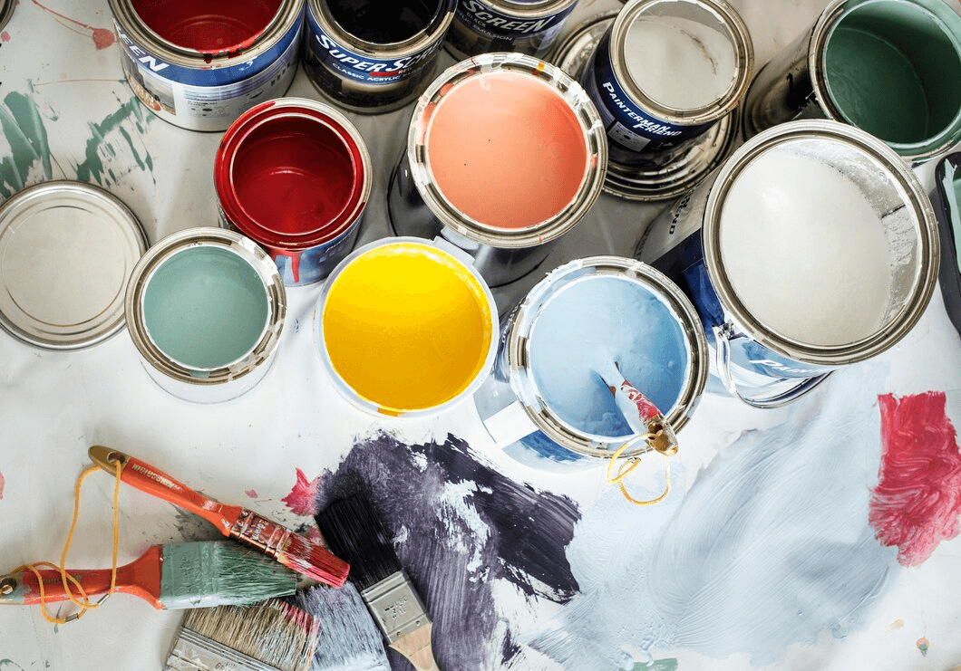 cans of paints and paint brushes