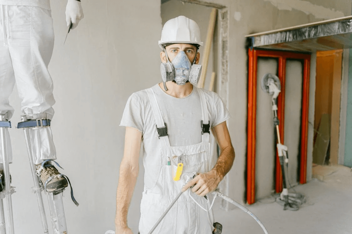 man wearing mask holding spray paint long island