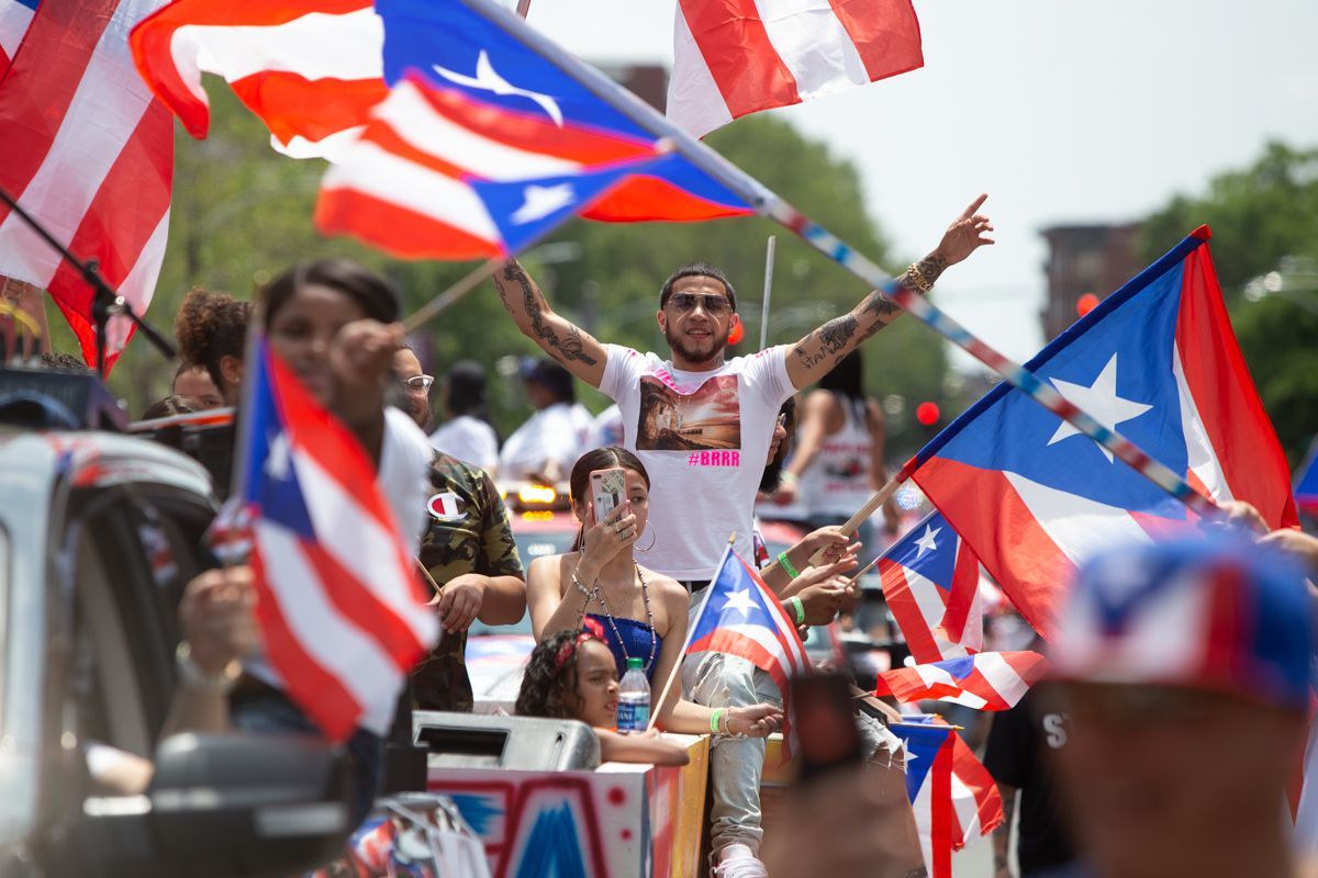 A group of people are holding flags in a parade.