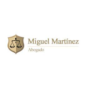 The logo for miguel martinez abogado is a shield with scales of justice on it.