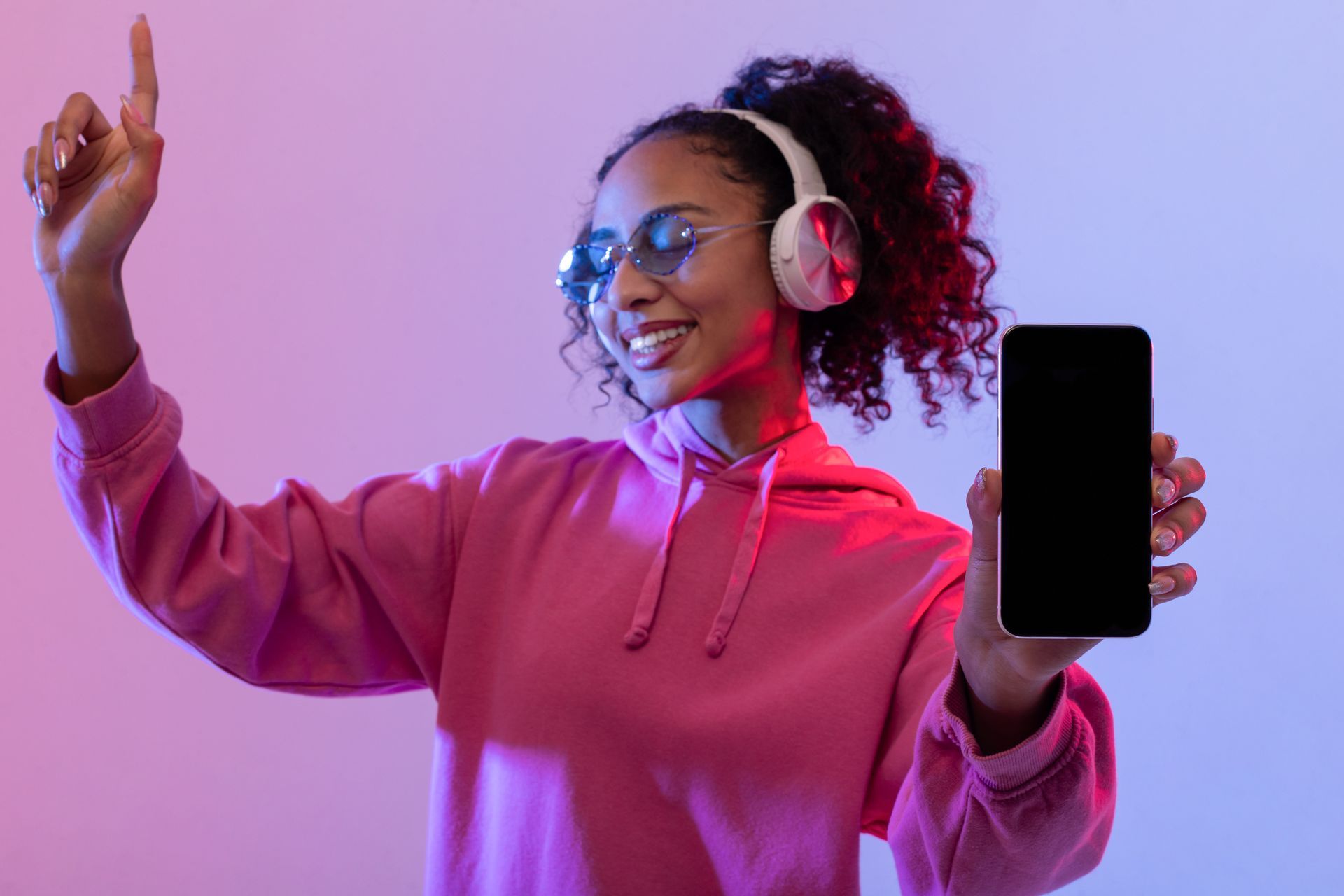 happy lady dancing with phone and headphones