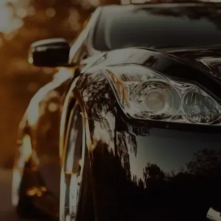 A black sports car is parked on the side of the road.