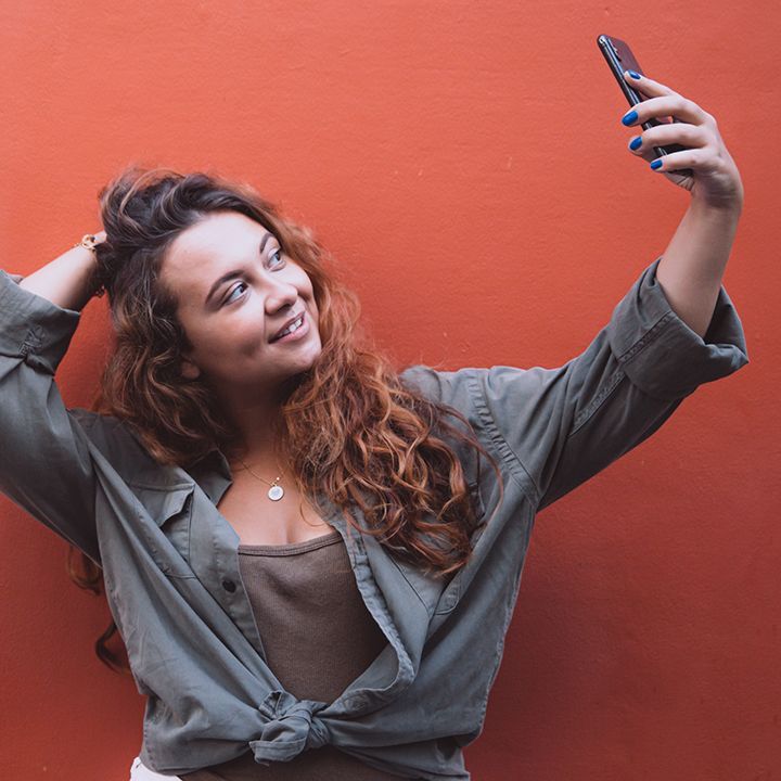 woman is taking selfie for social media