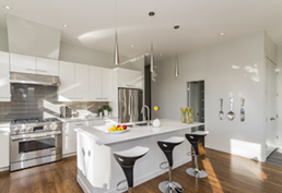 Black kitchen faucet with flexible spring and pull-down sprayer, white countertop.