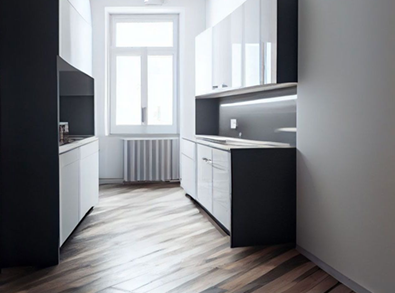 Modern kitchen with gray and white cabinets, wood flooring, and a window.
