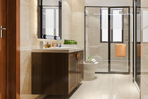 Bathroom with brown vanity, mirror, glass shower, and toilet.