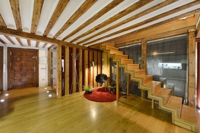 Finished Denver metro basement living room with a wood staircase