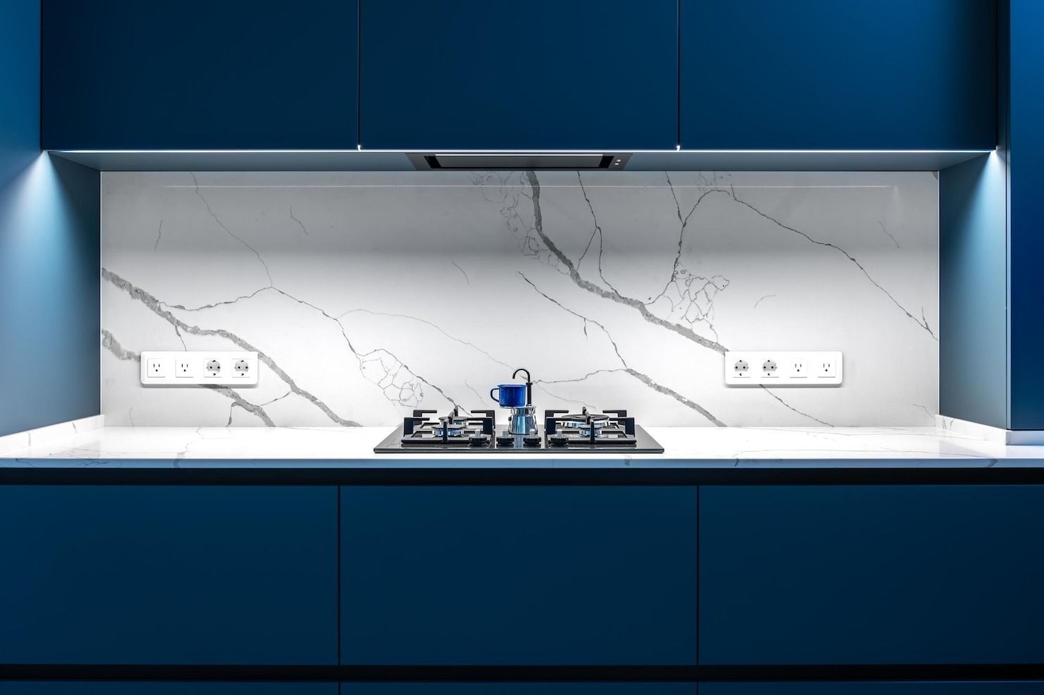 Black kitchen faucet with flexible spring and pull-down sprayer, white countertop.