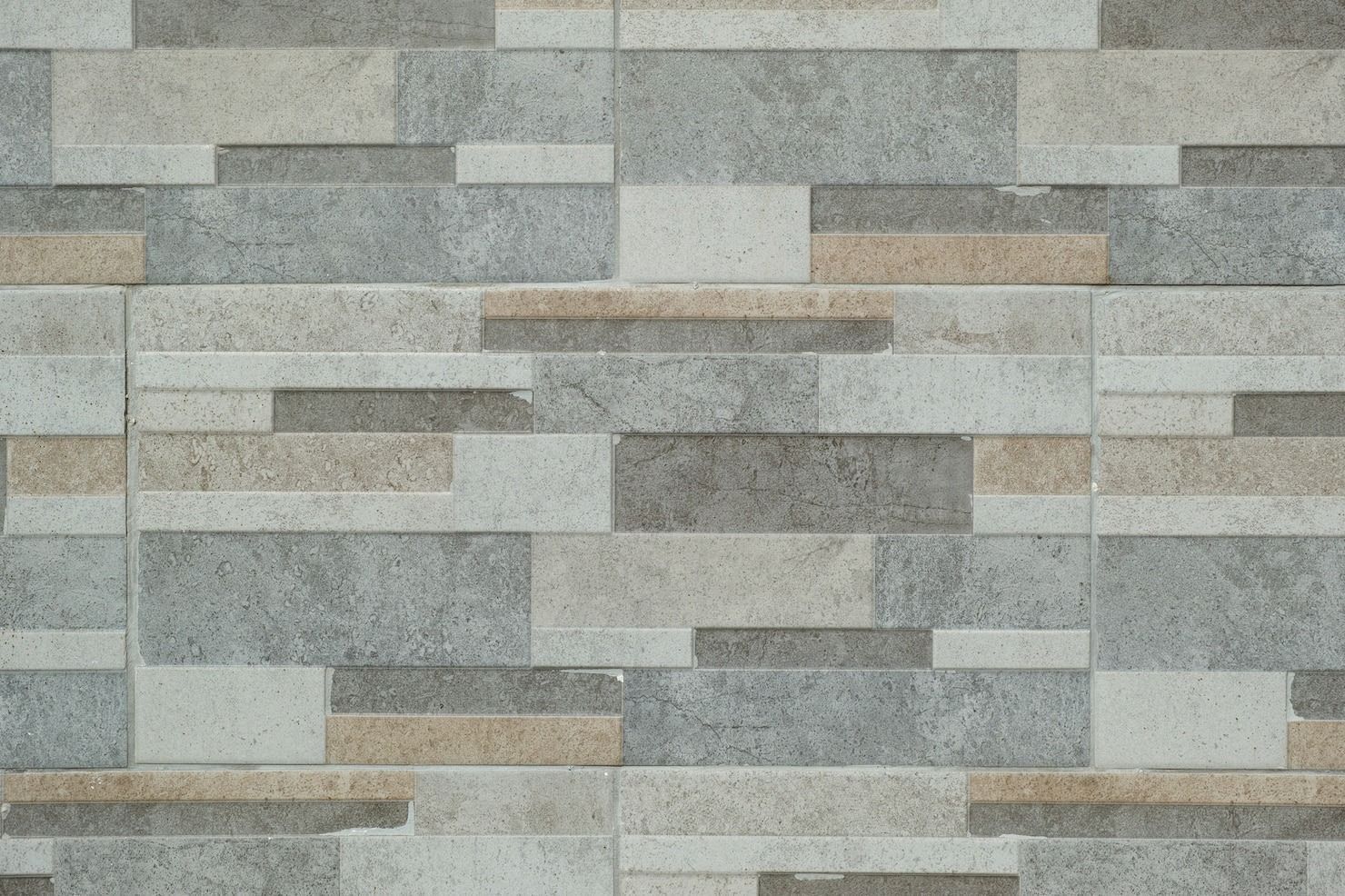 Man using a bow saw to cut wood in a workshop with tools and wood shavings.