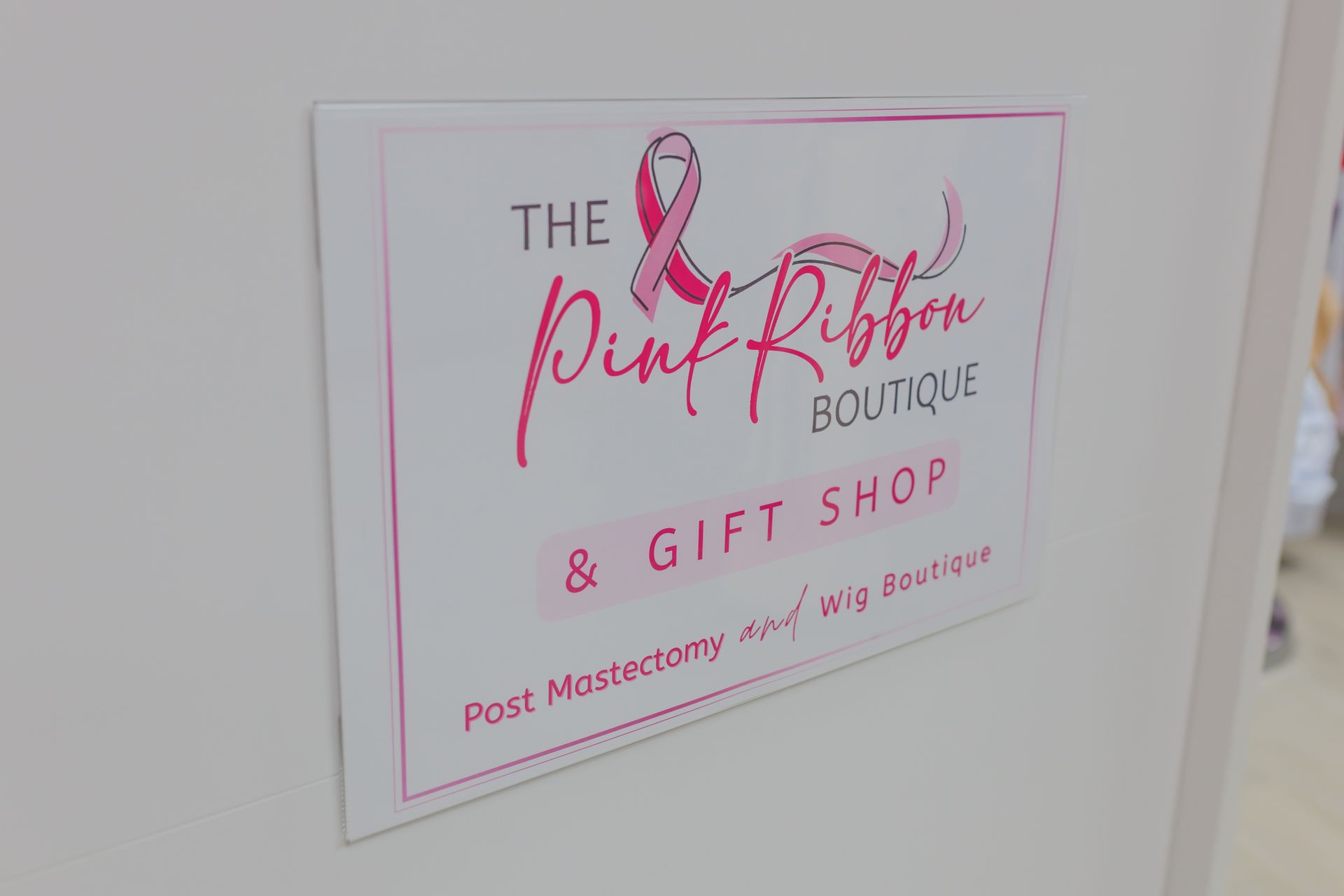 A sign for the pink ribbon boutique and gift shop