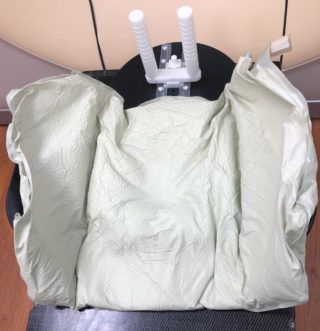A chair with a white blanket on top of it