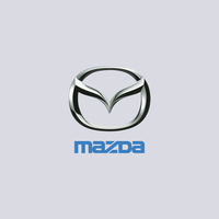 Mazda logo: Silver, stylized "M" within an oval frame, above blue "MAZDA" text.