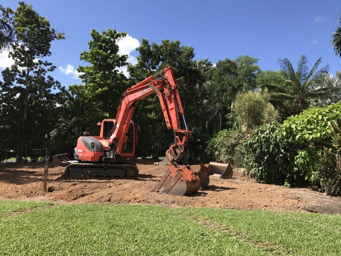 Worker Operating A Mini Digger — Earthworks in Edmonton, QLD