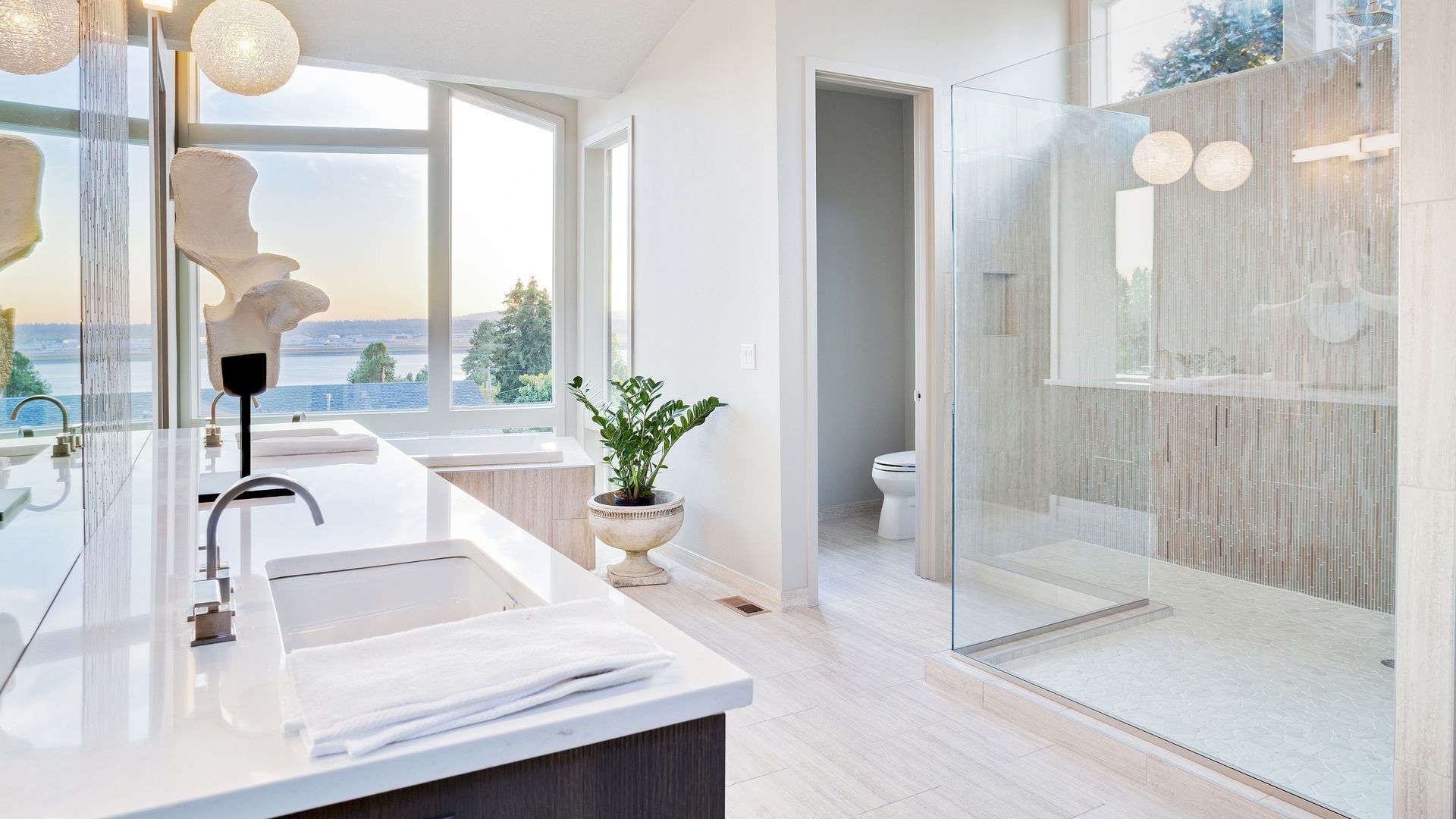 A bathroom with a walk in shower and a sink.