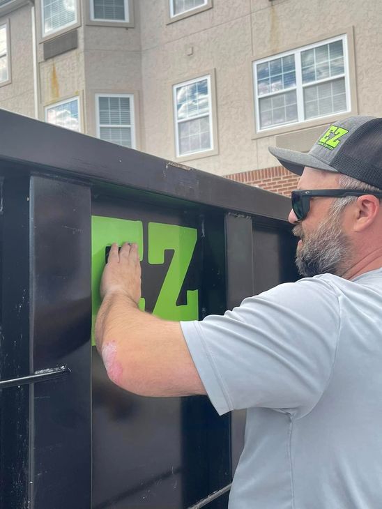 Man in sunglasses applies a large green