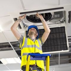 air con maintenance engineer in empty office floor