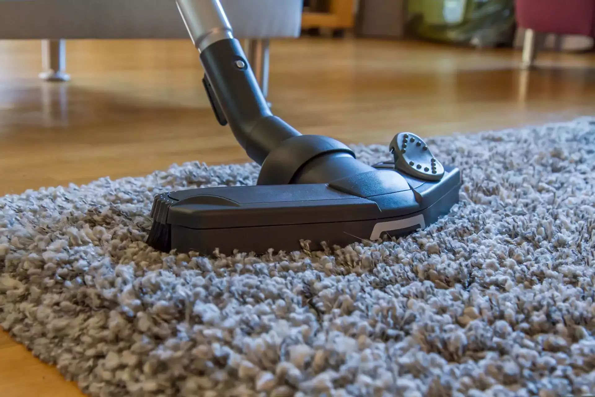 a vacuum cleaner is being used to clean a carpet