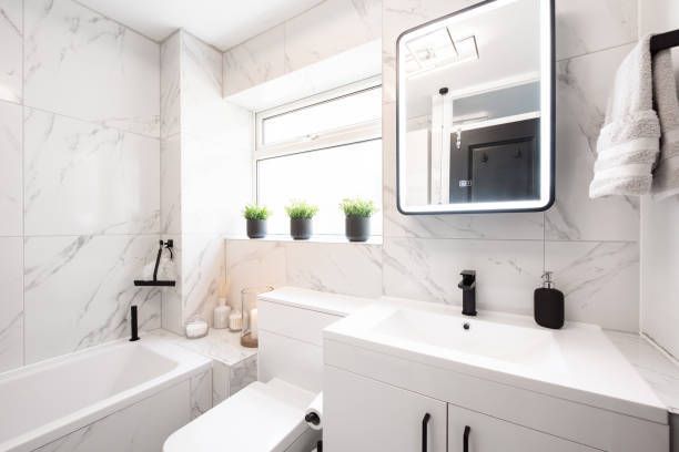 A bathroom with a sink , toilet , bathtub and mirror.