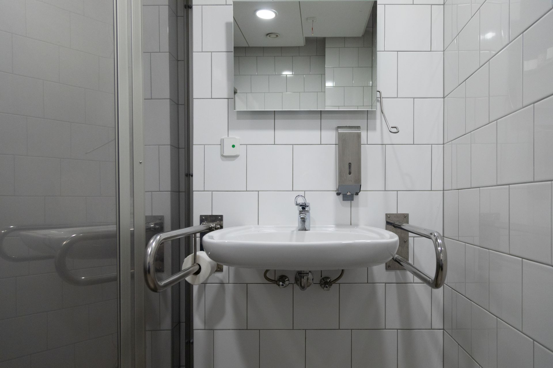 A bathroom with a sink and a mirror.