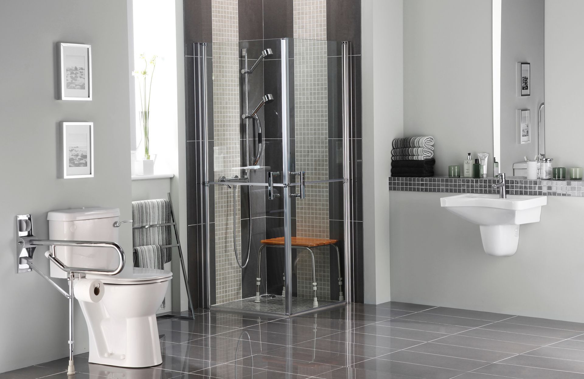 A bathroom with a toilet , sink , shower and mirror.