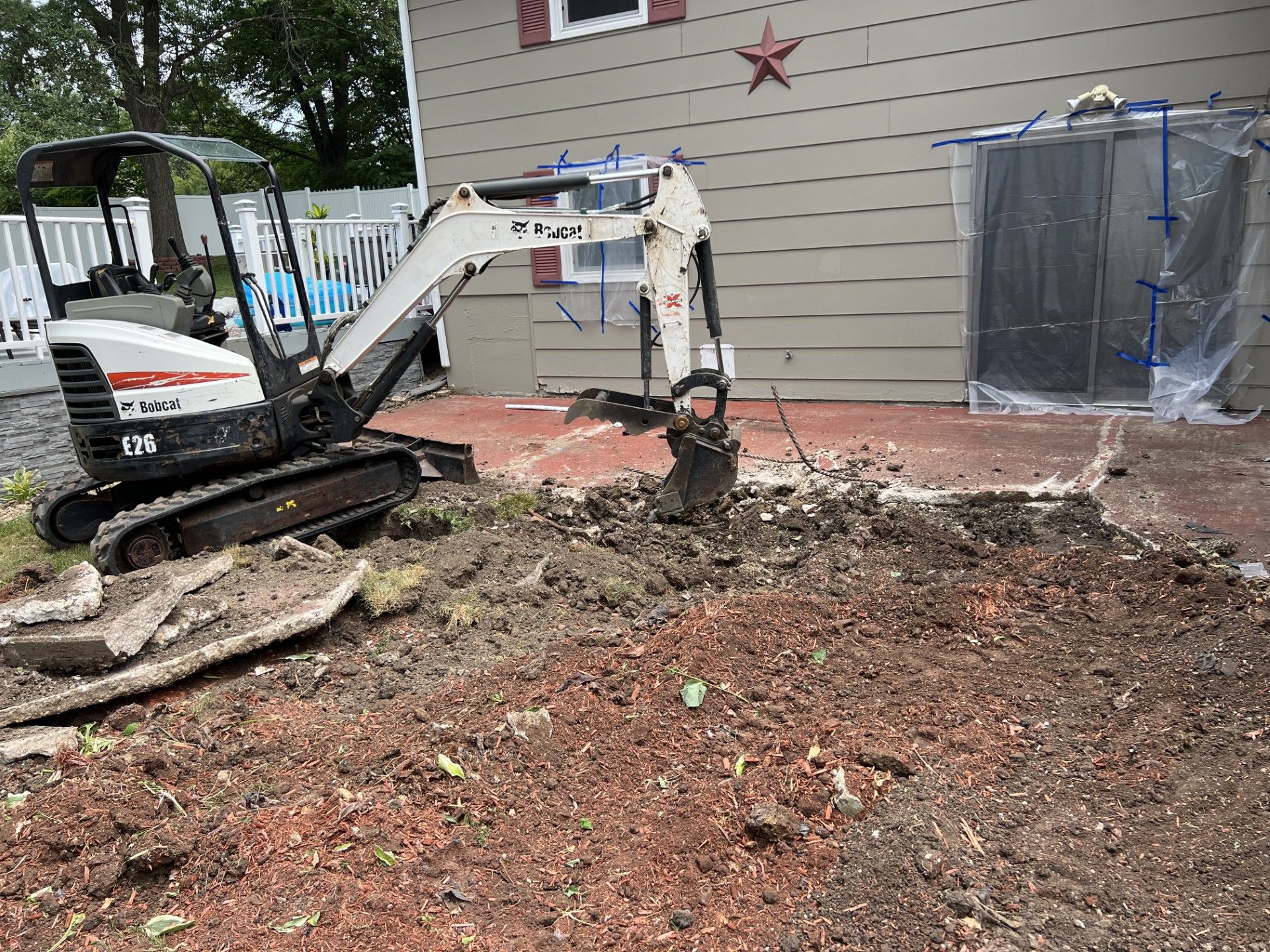 A yellow excavator is loading dirt into a dump truck.