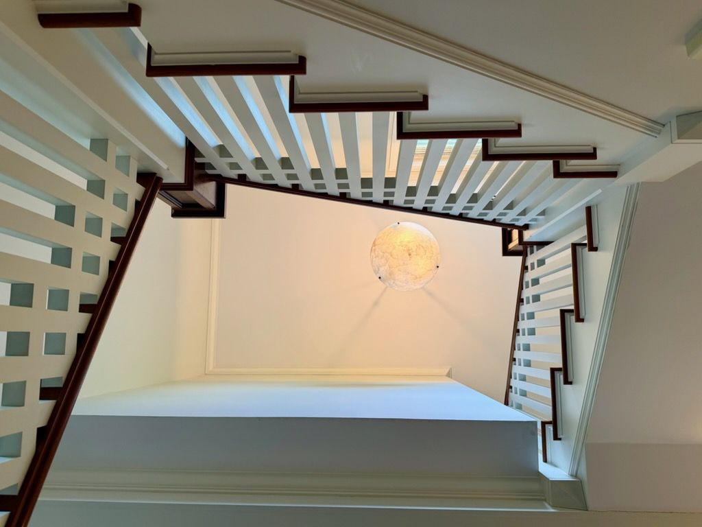 An upwards shot of an ascending spiral staircase
