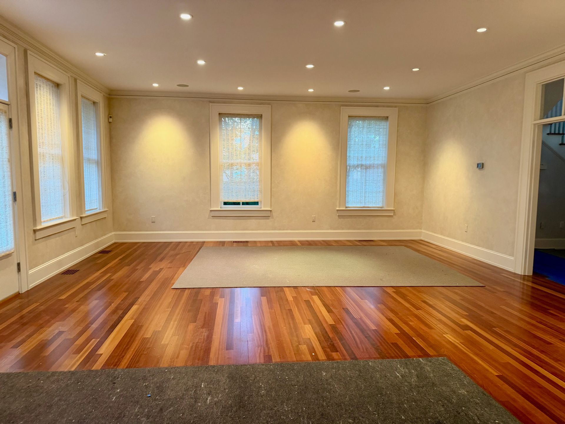A beautiful hardwood floor with freshly painted cream walls