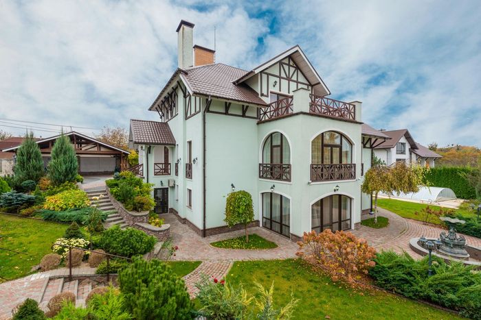An old english style house with white walls and brown trim
