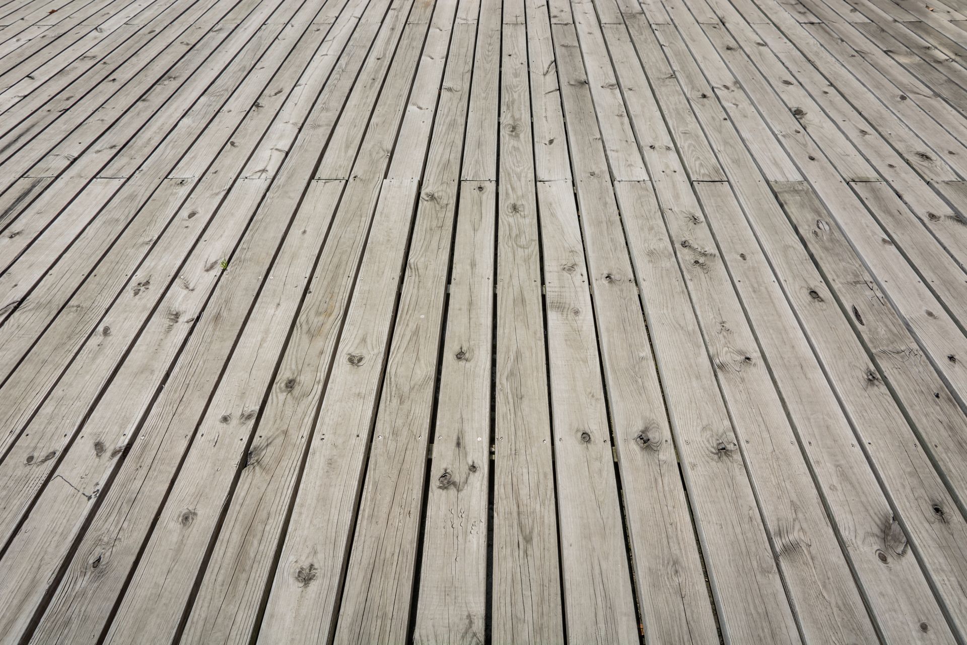 A black and white photo of a wooden deck