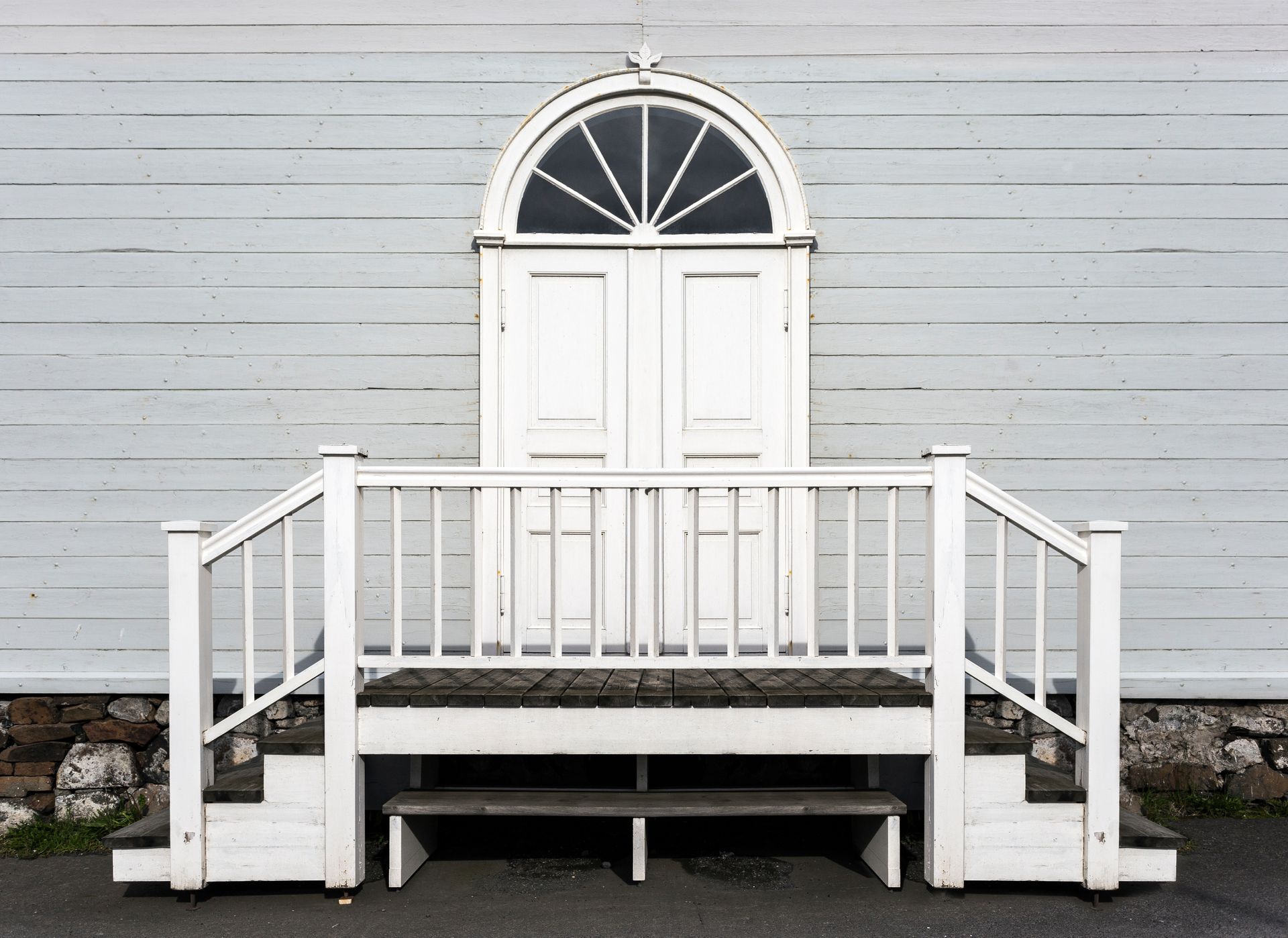 A white door with stairs leading up to it
