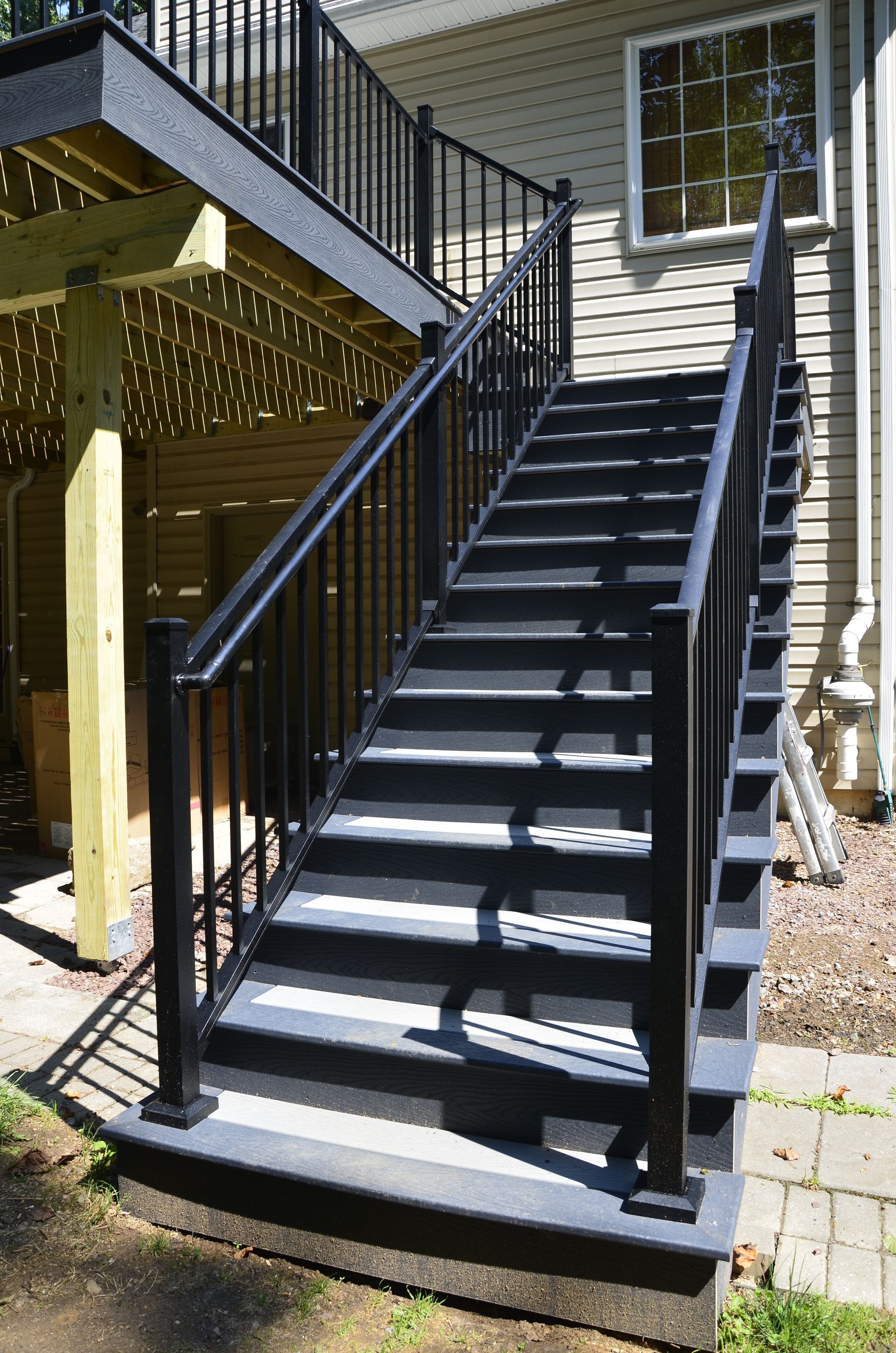 A set of black stairs leading up to a deck.