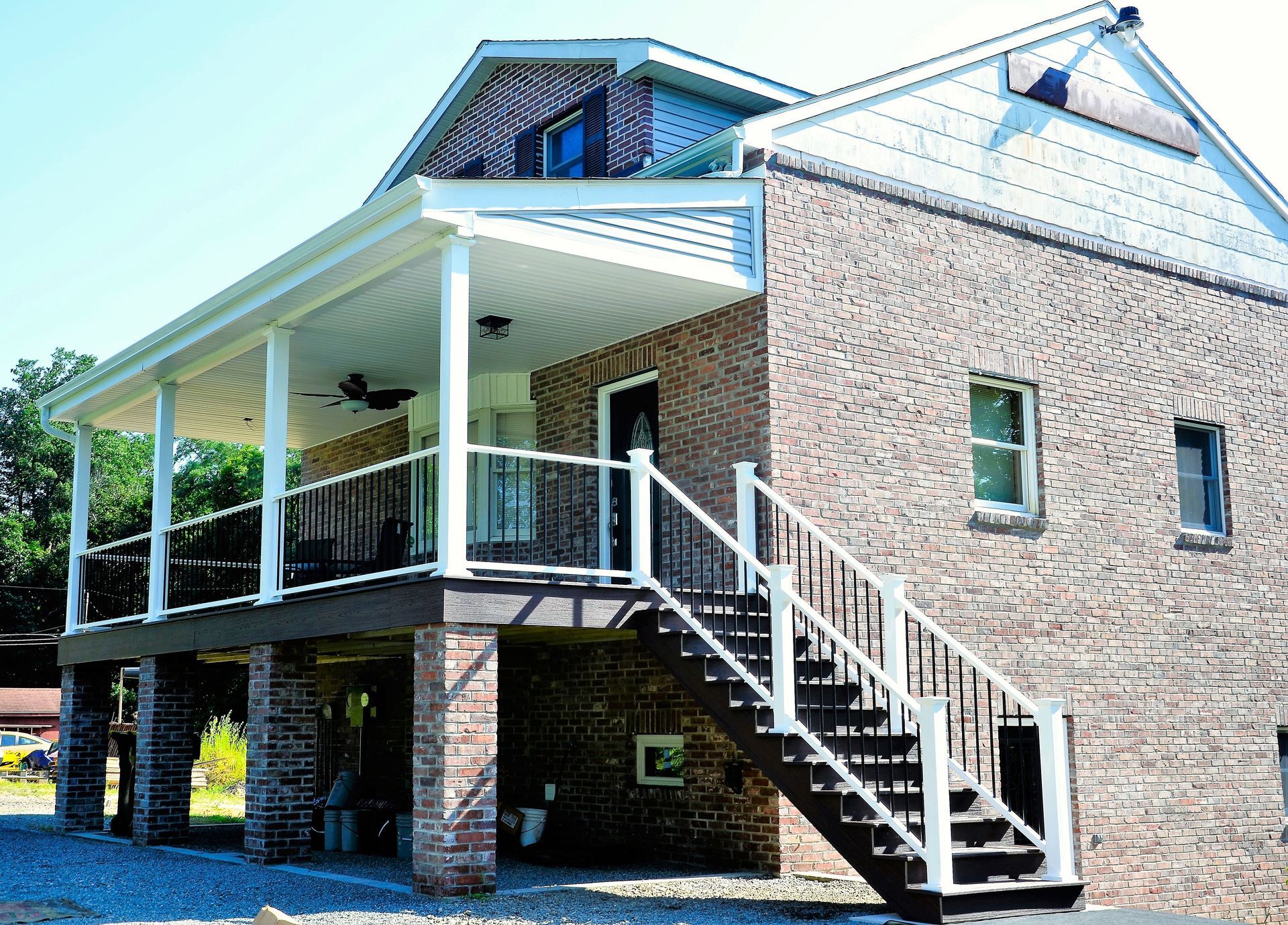 A brick house with stairs leading up to the second floor
