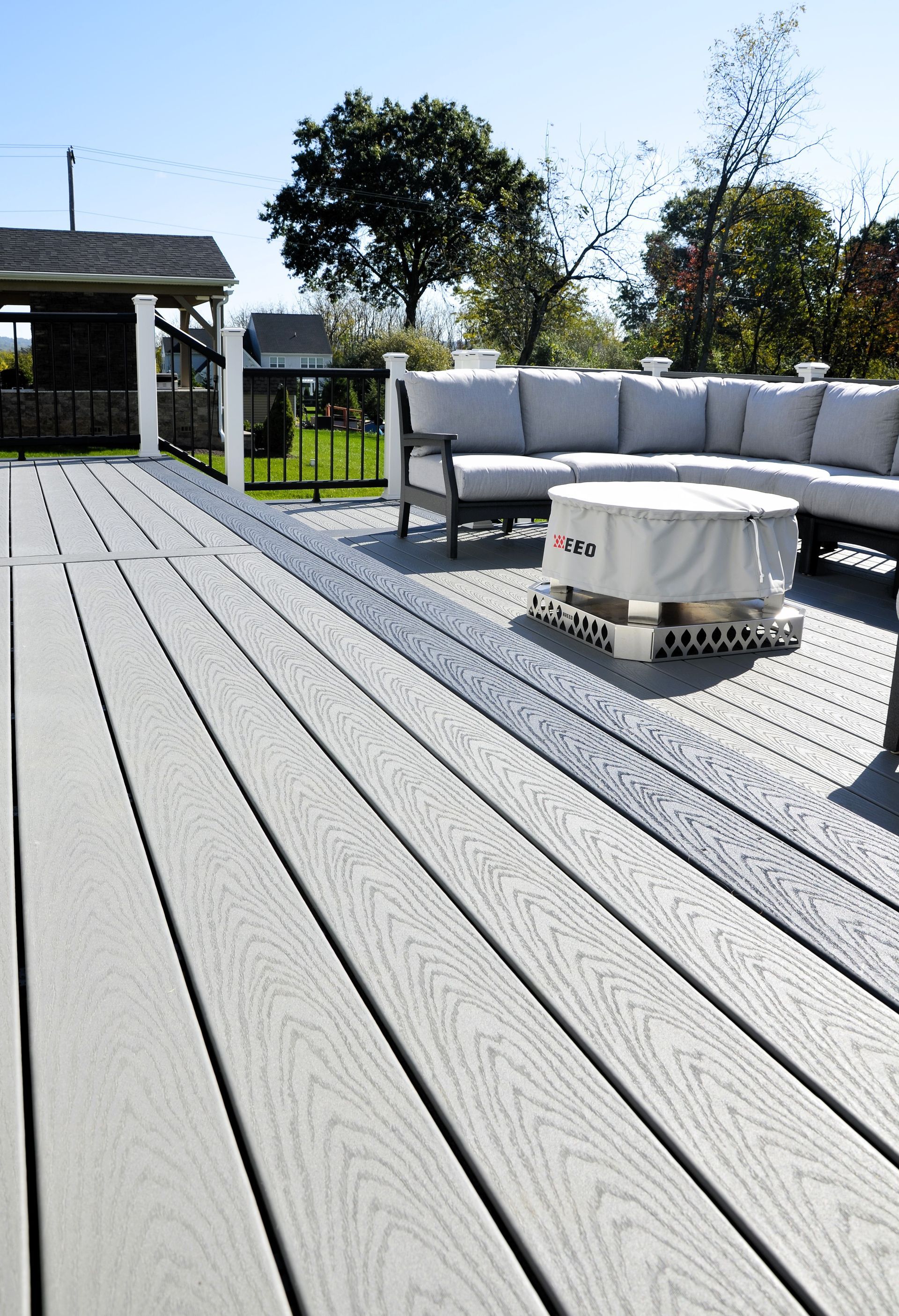 A deck with a couch and a table on it